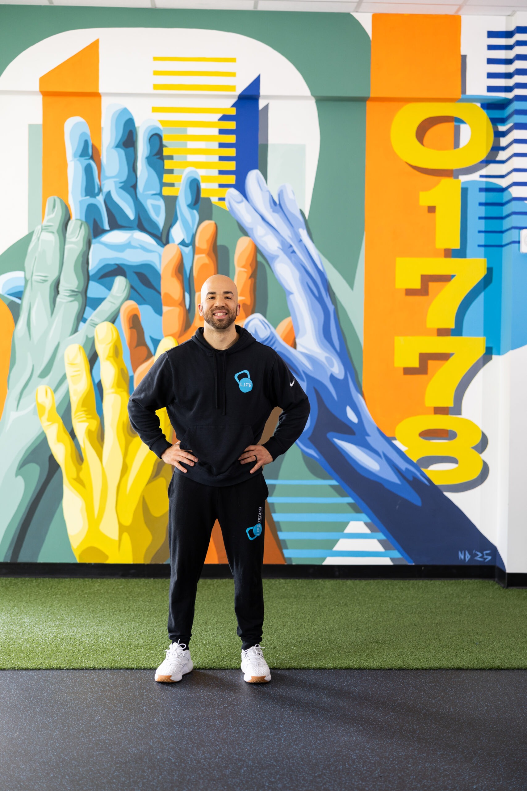 Curtis in front of the zip code mural