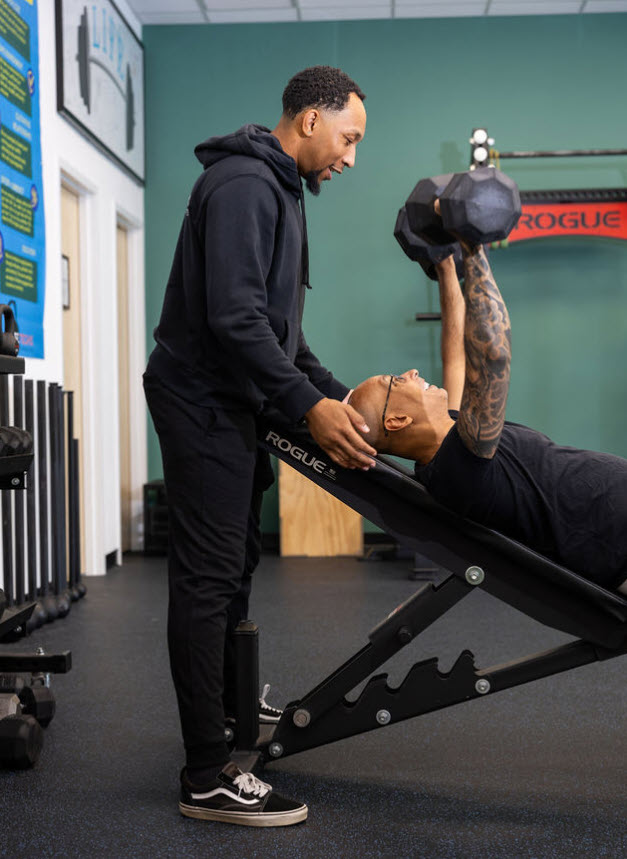 Personal training session at LifeTechs Fitness in Wayland MA with coach guiding strength training workout