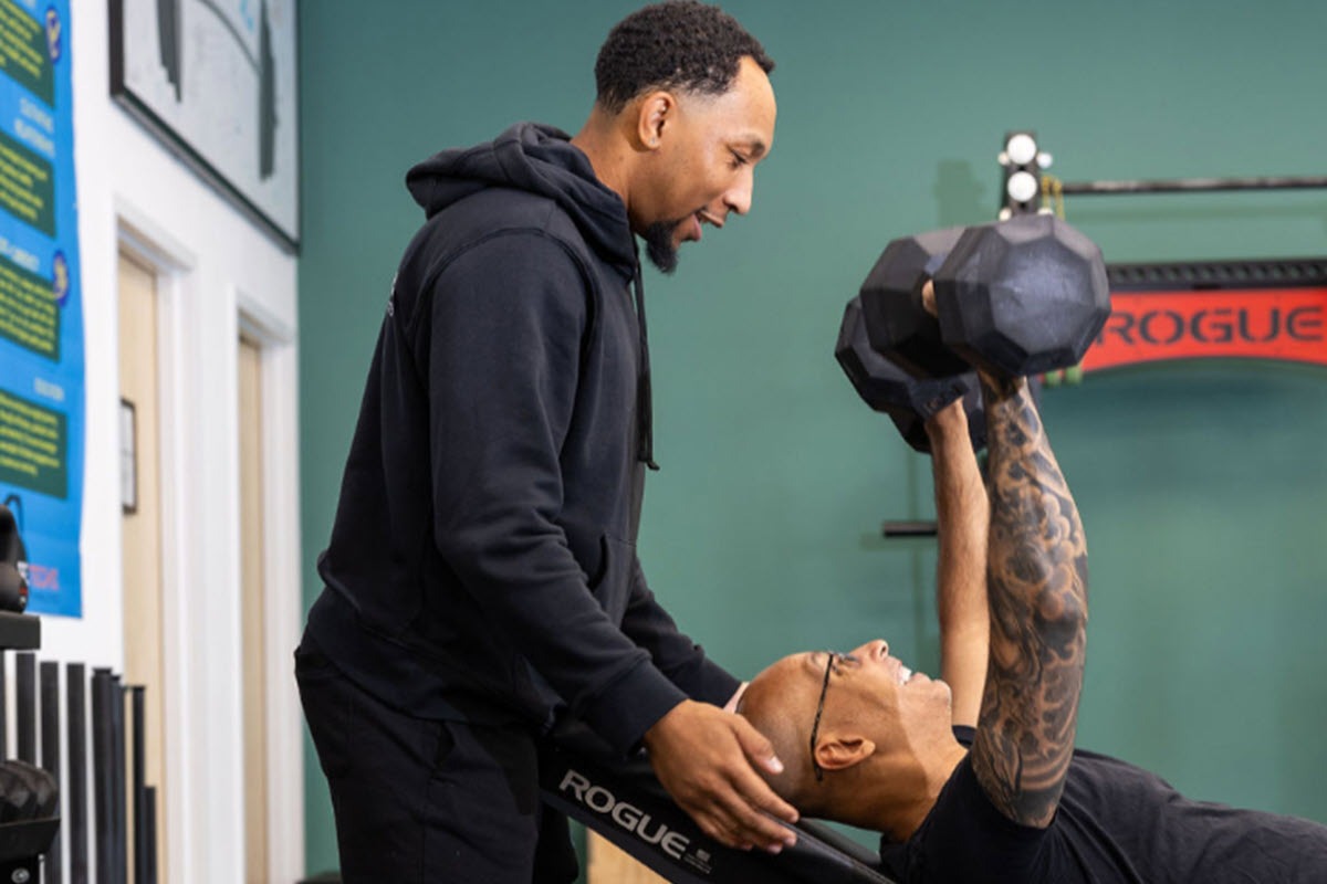 Personal trainer coaching a client during a strength training session at Life Techs Fitness in Wayland
