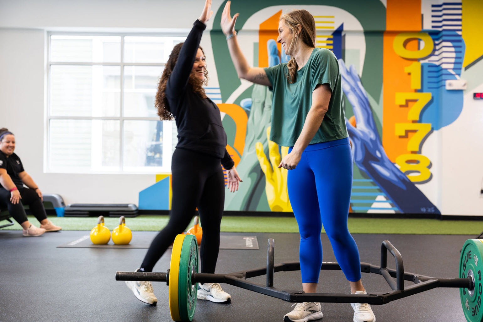 personal trainer encouraging client during strength training session at Life Techs Fitness Wayland MA
